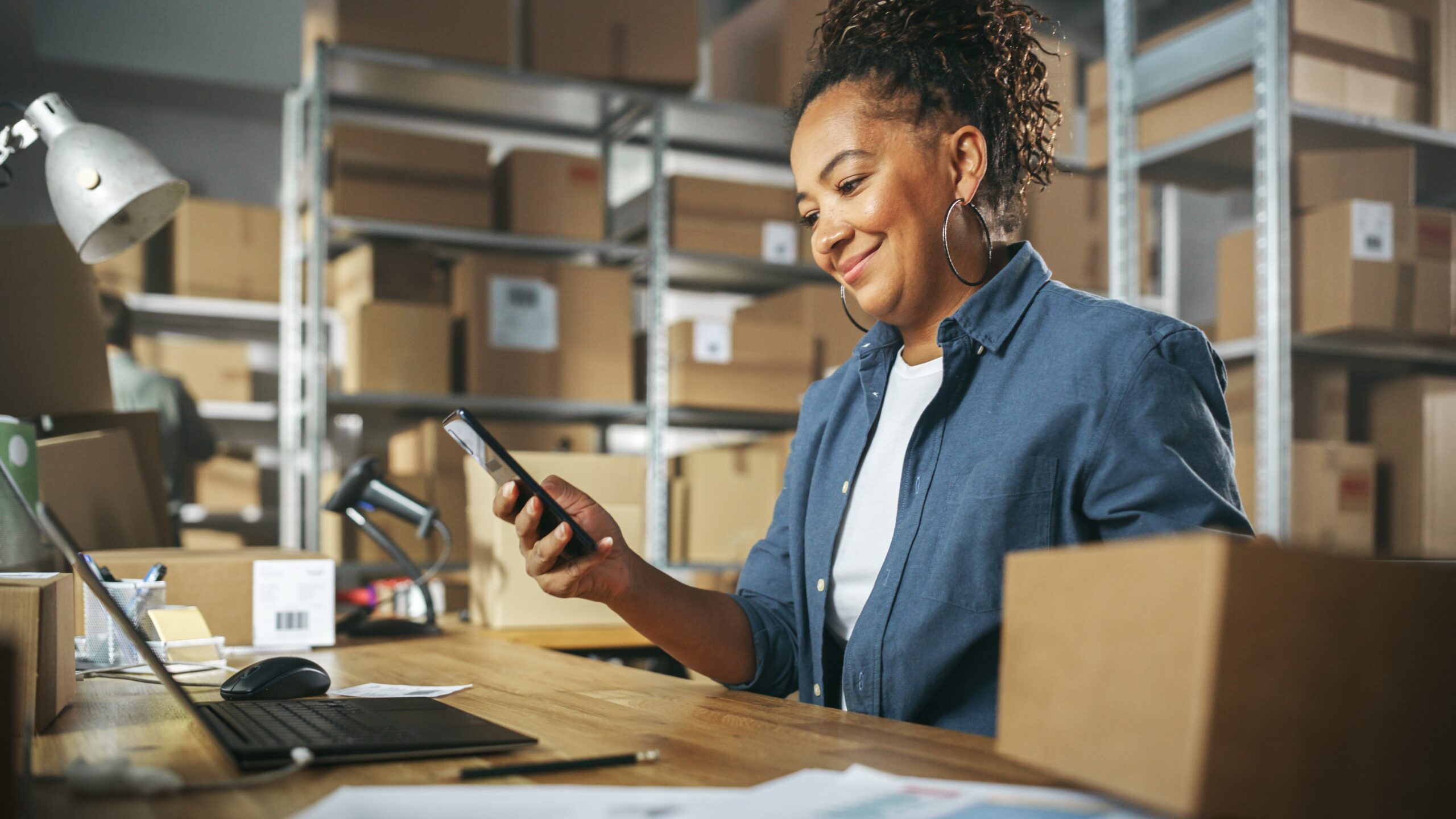 A small business owner confidently reviewing payroll reports, symbolizing hassle-free payroll tax management.