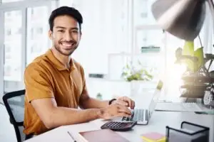 Blog 10 Small business owner reviewing payroll reports with a team in a modern NJ office setting.